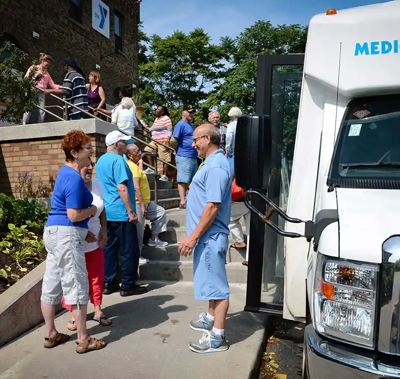 photo of people getting of MMS minibus and entering YMA building in Rochester, NY